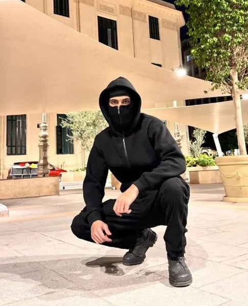 Construction worker wearing Stealth Tech balaclava hoodie, thermal ski mask zip-up providing warmth and protection for cold-weather job sites.